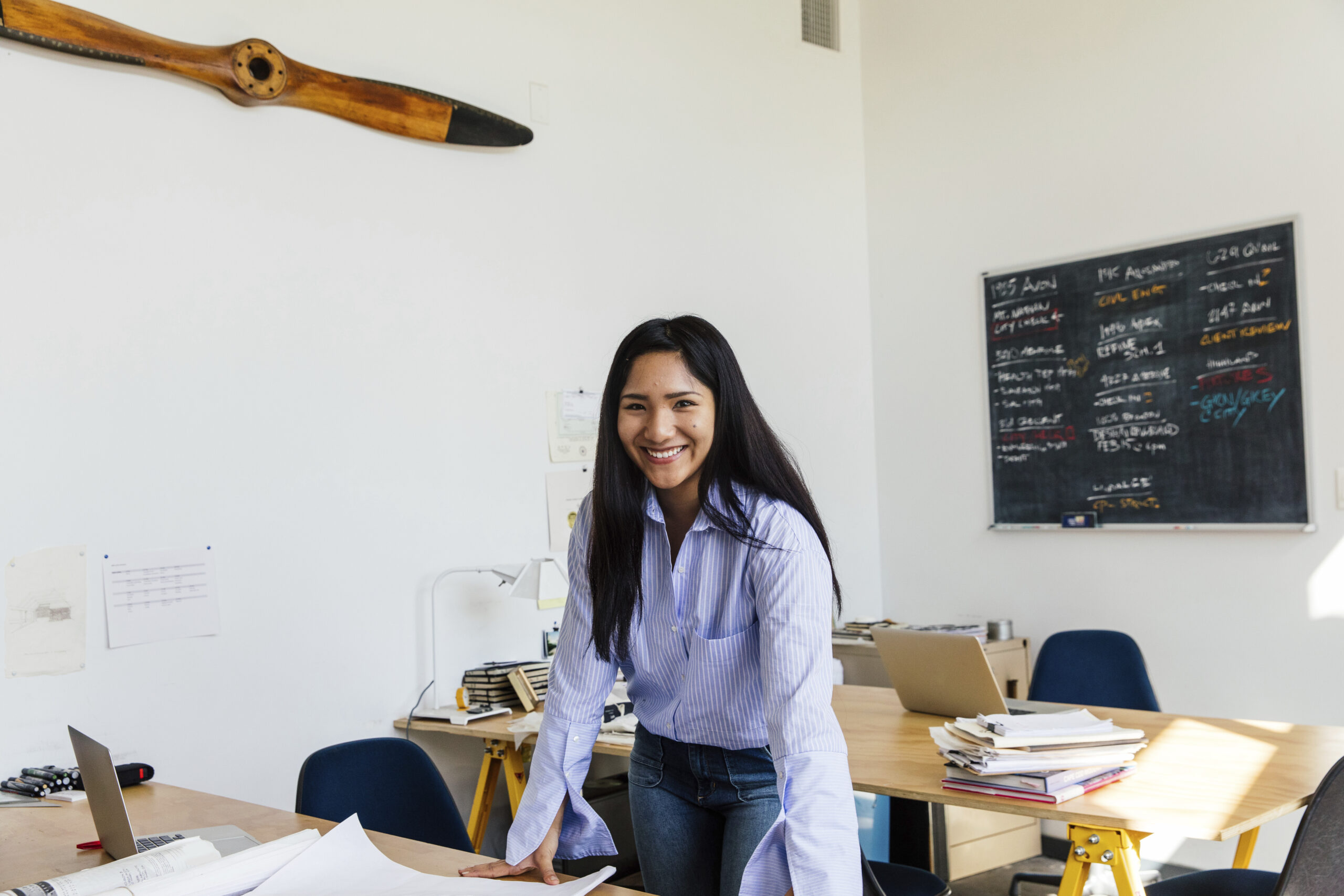 Portrait of woman in office looking at camera smiling